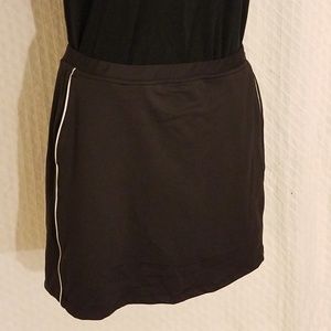 Black golf skort with white piping on each side